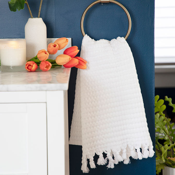 Decorative white tassel towel looks crips with Spring florals.