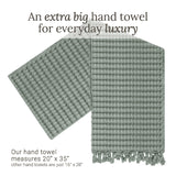 Waffle hand towel with decorative tassels on one end.