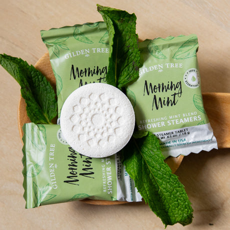 Morning Mint shower steamer individually wrapped tablets with mint leaves.