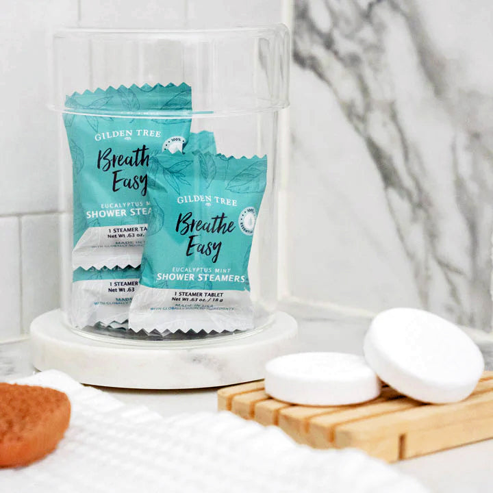 Breathe Easy Eucalyptus Mint Shower Steamers displayed in pretty glass jar on your bathroom counter.