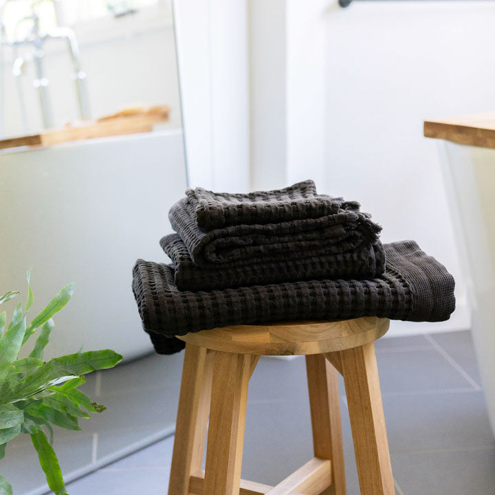 Faded black waffle bath towels add a dramatic touch to your bathroom decor. 