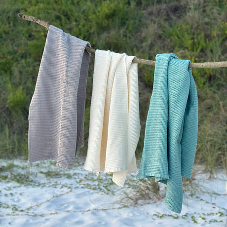 Pewter, Cream and Seafoam waffle bath towels on a beachy sand dune