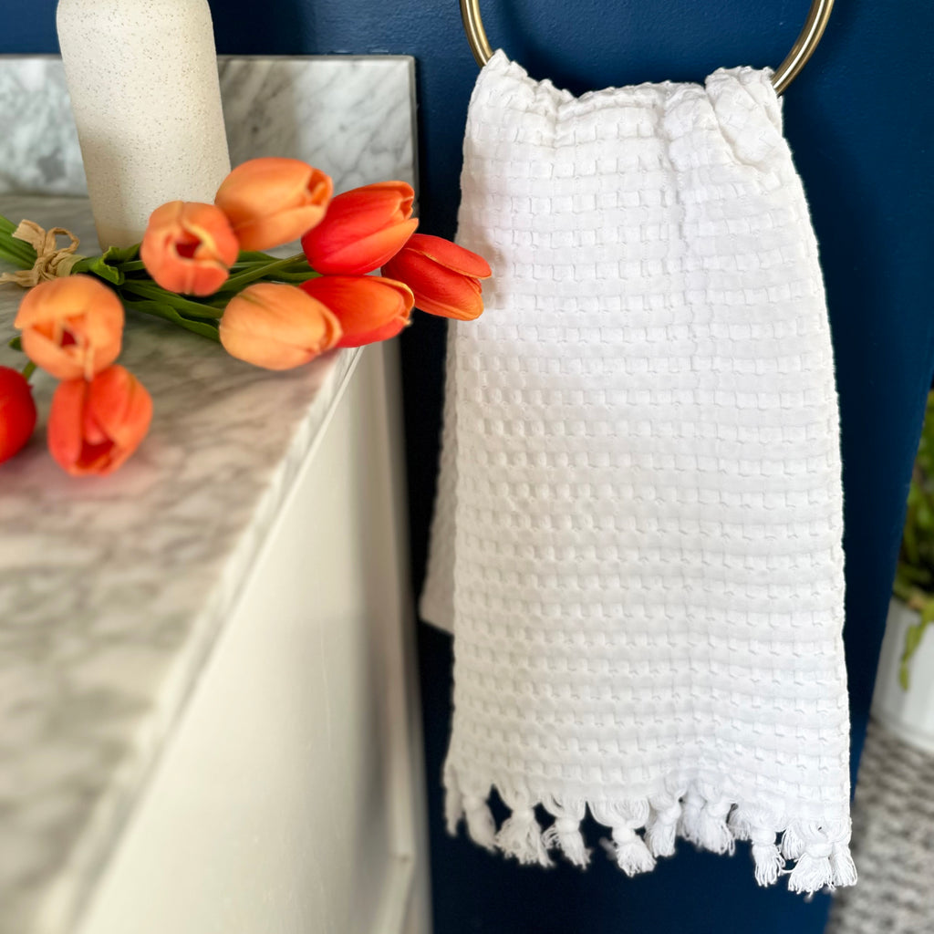 Decorative white tassel towel looks crips with Spring florals.