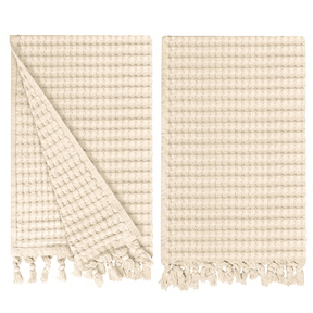Gilden Tree waffle hand towels for bathrooms with new decorative tassels shows a folded towel.