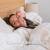 Woman laying in bed calmed and restored after using Relax Deeply shower steamers.