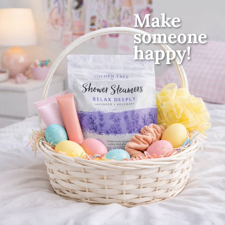Gift basket with pastel-colored bath bombs and a shower steamer labeled 'Relax Deeply' on a soft surface.