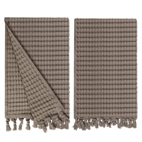 Gilden Tree waffle hand towels for bathrooms with new decorative tassels shows a folded towel.