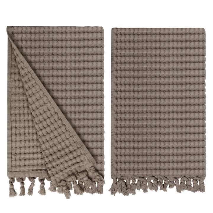 Gilden Tree waffle hand towels for bathrooms with new decorative tassels shows a folded towel.