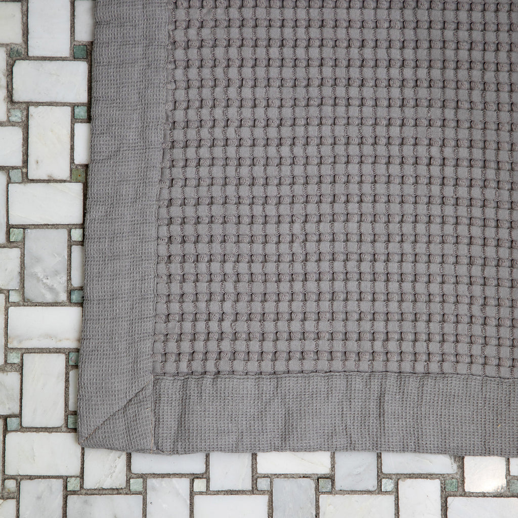 Pewter waffle bath mat is cushy and absorbent.