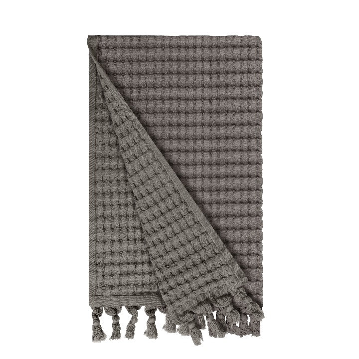 Gilden Tree waffle hand towels for bathrooms with new decorative tassels shows a folded towel.